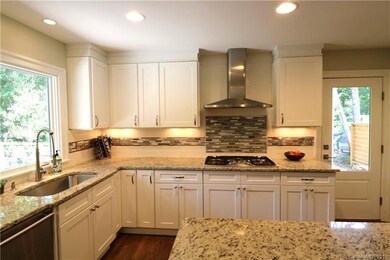Bright chef's kitchen includes a large island, far