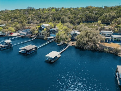 Aerial view with a water view and a view of trees