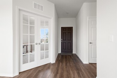 Unfurnished living room featuring dark wood finished floors, a fireplace with raised hearth, and recessed lighting