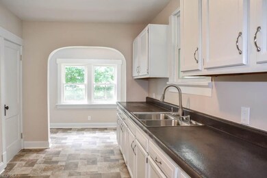 Updated kitchen with painted cabinets and resurfac