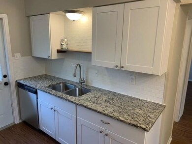Kitchen with dark wood-type flooring, backsplash, 