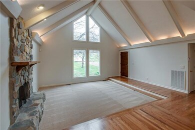 Enter into the Living Room. This room has vaulted ceilings with floor to ceiling windows.
