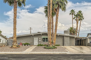 Mid-century home with stucco siding, an attached c