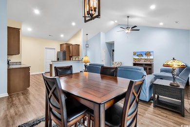 Dining room with light wood finished floors, visib
