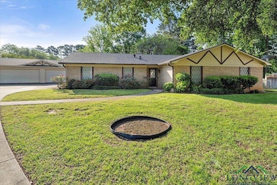 Ranch-style home with brick siding and a front yar
