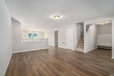 There is an abundance of natural light in the great room.  The stairs to the second floor are discreetly located, maximizing the living space.