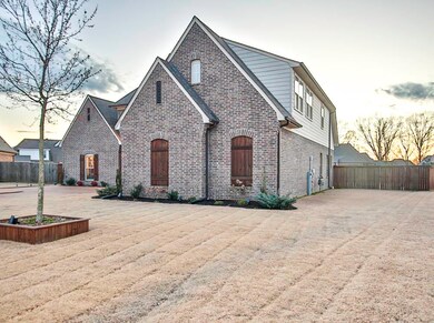 View of front of home with fence and brick siding