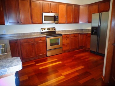 Gorgeous wood flooring and cabinetry in beautiful 