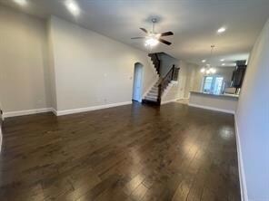 living room with dark wood-type flooring and ceili