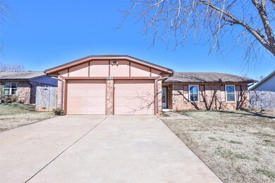 Ranch-style home with a front lawn and a garage