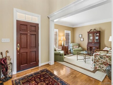 Two story foyer with hardwood floors and showcases