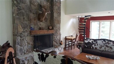 Living room with a stone fireplace that extends to