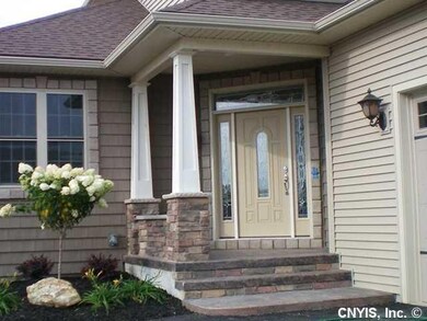 Exterior Front. The front door is surround with a 