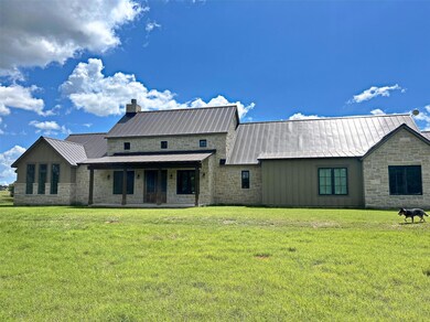 View of front of home with stone siding, a front 
