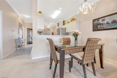 Dining room featuring light carpet, baseboards, an