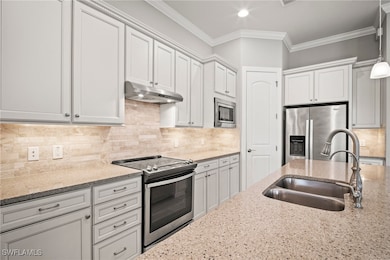 Kitchen featuring stainless steel appliances, unde