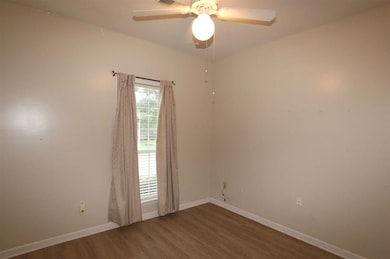 Spare room with visible vents, baseboards, a ceili