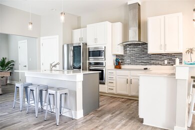 Kitchen featuring a breakfast bar, an island with 