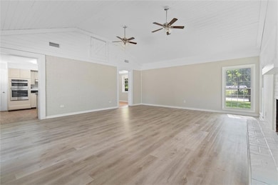 Unfurnished living room featuring baseboards, a ce
