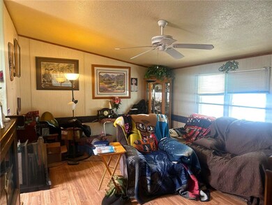 Living area with ornamental molding, vaulted ceili