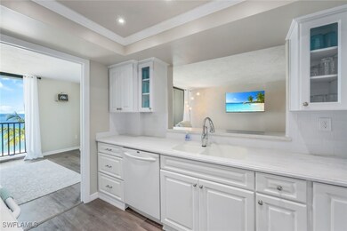Kitchen with white cabinetry, hardwood / wood-style flooring, backsplash, sink, and dishwasher