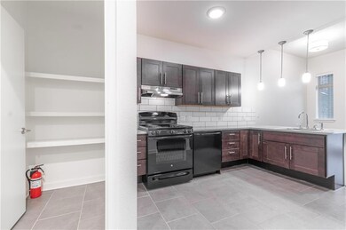 Kitchen featuring black appliances, under cabinet