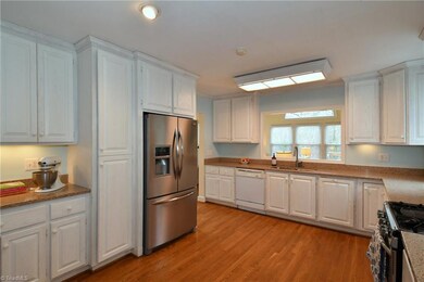 Kitchen with granite counters and hardwoods. Lots of cabinet and counter space!