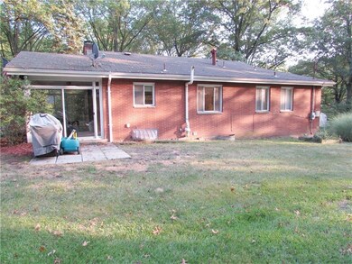 It has an Open Floor Plan & Level Back Yard, which