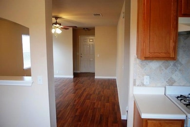 Kitchen with ceiling fan, dark wood finished floo