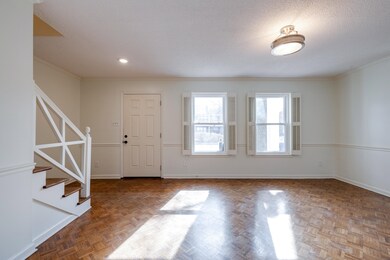 Entryway featuring dark parquet flooring, ornament