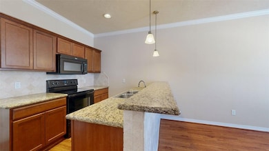 Kitchen featuring black appliances, decorative bac