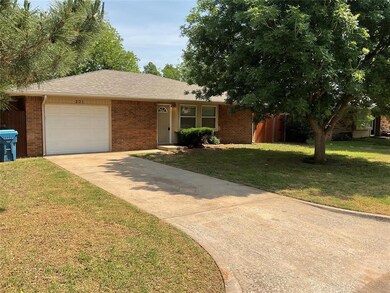 Ranch-style house with brick siding, a garage, and driveway