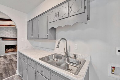 Kitchen with gray cabinets, hardwood / wood-style 