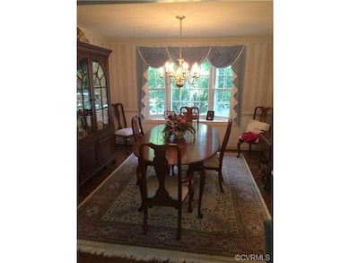 Formal dining room with wood floor, crown moulding