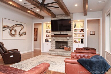 Great room with stone fireplace surrounded by buil