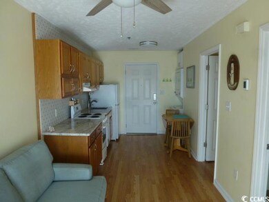 Kitchen featuring ceiling fan, backsplash, white r