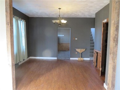 Dining room with barnwood beams. There is laundry 