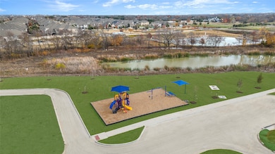 View of property's community with a water view and a yard