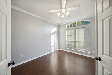 This is a bright study  featuring dark hardwood fl