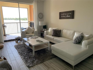 Living room featuring a water view and wood tiled floors