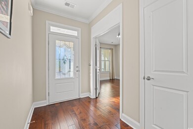 Entrance foyer with dark hardwood / wood-style flo