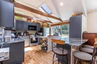 Kitchen with beamed ceiling & skylight
