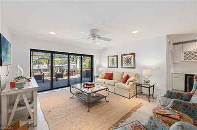 Living room featuring ceiling fan, light hardwood 
