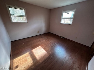 Empty room with wood finished floors and baseboards