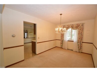 Dining room off kitchen with chair rail and pictur