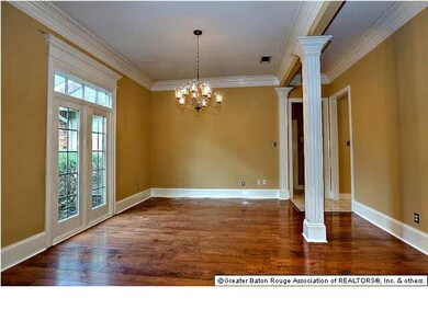 FORMAL DINING ROOM WITH FLUTED COLUMNS, WOOD FLOOR