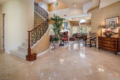 The curved staircase, travertine floors and dramat