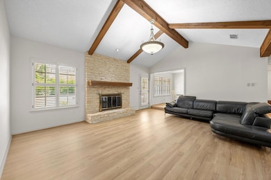Living room with light wood finished floors, a fi