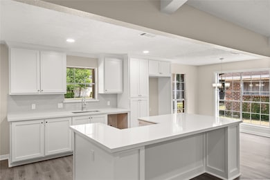 This spacious kitchen features large windows, high