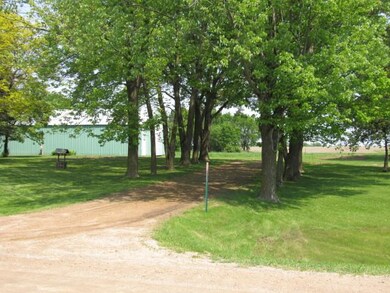 Tree-lined driveway access to Greenfield Road.